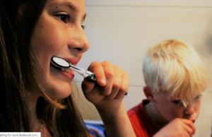 mom and son brushing their teeth 